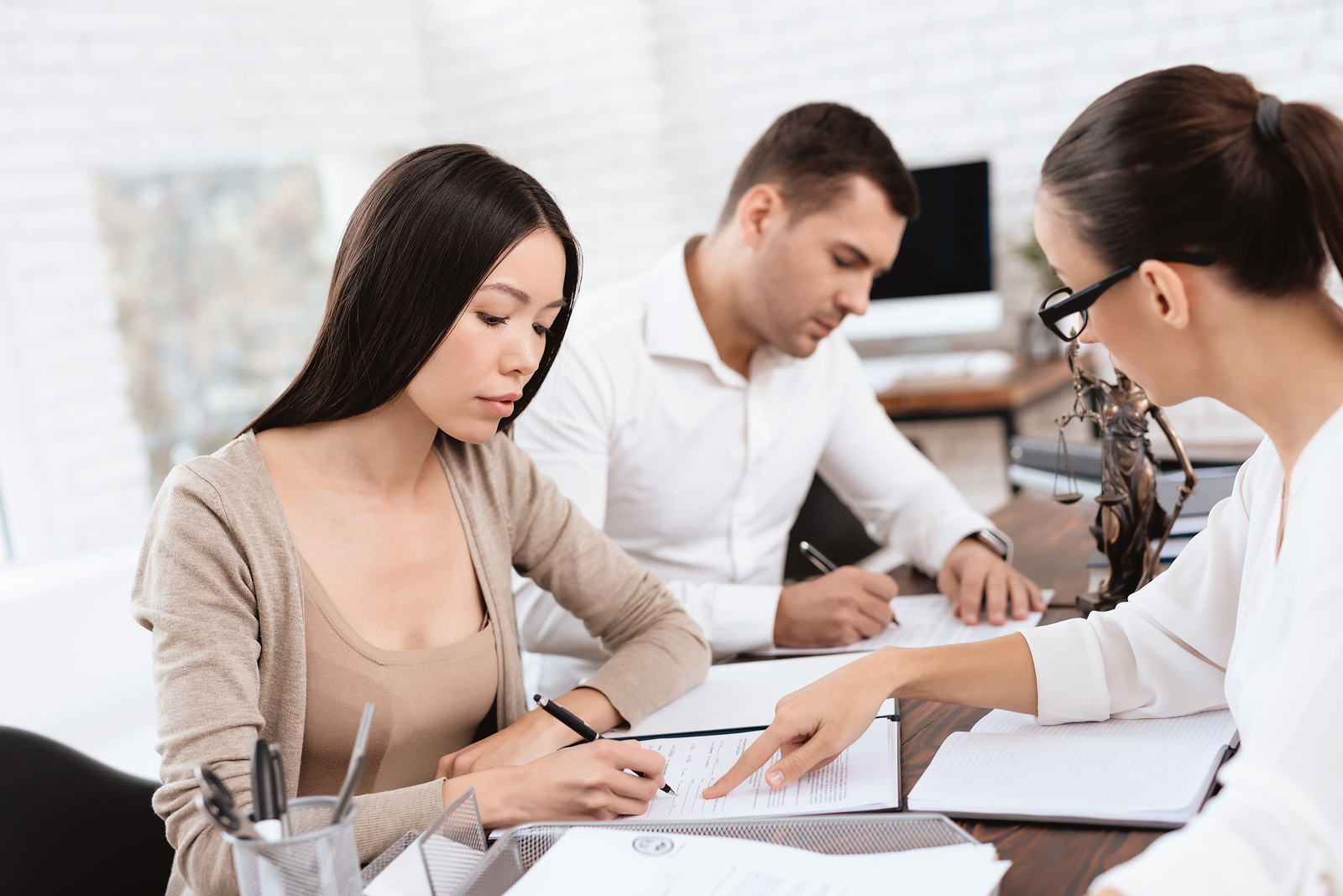The couple went to a lawyer to conclude an agreement on the divorce. They quarrel and argue with each other. Lawyer prepares documents.
